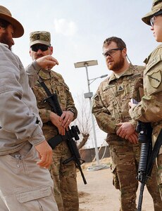 Civilian Agricultural Specialist Jon Mixon (2nd from right) speaks with a local nongovernmental organization representative in southern Afghanistan February 20, 2012. Mixon is a member of the Kentucky National Guard's Agribusiness Development Team 4, whose mission to help Afghan locals develop more effective farming and business practices by providing education and sustainable tools. Also pictured (from left) are Army Master Sgt. Christopher Campbell and Army Sgt. 1st Class Catherine Corson, Kentucky National Guard.