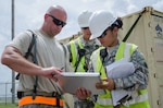 Sgt. Claribel Lopez Feliciano, yard boss for the U.S. Army’s 688th Rapid Port Opening Element, signs a manifest for cargo from Staff Sgt. Kevin Freese, an aerial porter for the Kentucky Air National Guard’s 123rd Contingency Response Group, before the cargo is shipped to a staging area called the forward node during Capstone '14, a homeland earthquake-response exercise at Fort Campbell, Ky., on June 18, 2014. The 123rd CRG is joining with the 688th RPOE to operate a Joint Task Force-Port Opening here from June 16 to 19, 2014. 