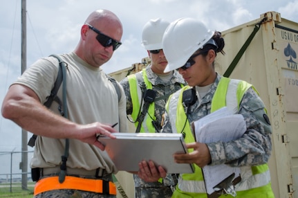 Sgt. Claribel Lopez Feliciano, yard boss for the U.S. Army’s 688th Rapid Port Opening Element, signs a manifest for cargo from Staff Sgt. Kevin Freese, an aerial porter for the Kentucky Air National Guard’s 123rd Contingency Response Group, before the cargo is shipped to a staging area called the forward node during Capstone '14, a homeland earthquake-response exercise at Fort Campbell, Ky., on June 18, 2014. The 123rd CRG is joining with the 688th RPOE to operate a Joint Task Force-Port Opening here from June 16 to 19, 2014. 