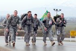 Members of the Wisconsin National Guard's 32nd Military Police Company (left to right) Army Staff Sgt. Joseph Currey, Army Staff Sgt. Andrew Harris, Army Capt. Craig. Keller, Army Spc. Anthony Collins, Army Sgt. Johnny Ferreira and Army Sgt. Alexander Henninger finished third in the heavy team category of a 13.1-mile Bataan Memorial Death March, held March 26, 2012 at Camp Bondsteel, Kosovo.