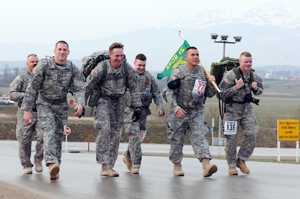 Members of the Wisconsin National Guard's 32nd Military Police Company (left to right) Army Staff Sgt. Joseph Currey, Army Staff Sgt. Andrew Harris, Army Capt. Craig. Keller, Army Spc. Anthony Collins, Army Sgt. Johnny Ferreira and Army Sgt. Alexander Henninger finished third in the heavy team category of a 13.1-mile Bataan Memorial Death March, held March 26, 2012 at Camp Bondsteel, Kosovo.