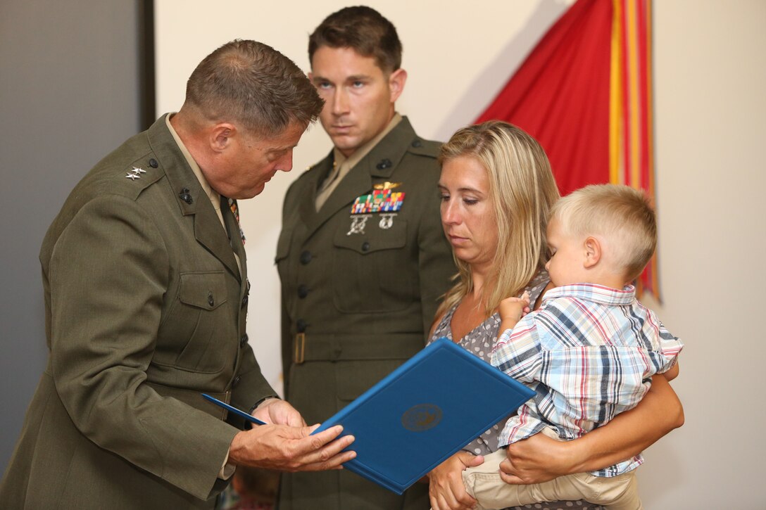 Major Gen. Mark A. Clark, commanding general, U.S. Marine Corps Forces Special Operations Command, presents the Navy Cross citation to the wife of Gunnery Sgt. Jonathan Gifford, a team chief with 2d Marine Special Operations Battalion, U.S. Marine Corps Forces Special Operations Command, during a ceremony at Stone Bay aboard Marine Corps Base Camp Lejeune, N.C., June 17.  Gifford was posthumously awarded the Navy Cross for his actions while serving with Combined Joint Special Operations Task Force Afghanistan in support of Operation Enduring Freedom in July 2012. The Navy Cross is the highest decoration bestowed by the Department of the Navy and second highest decoration for valor.
