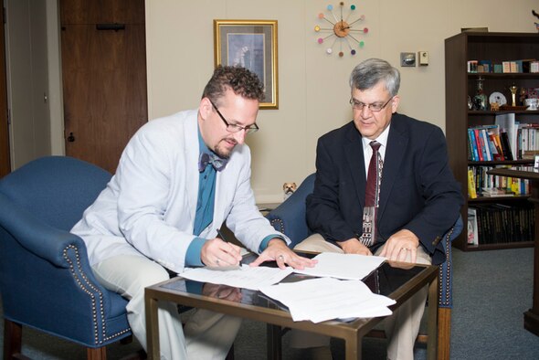 Dr. Christopher Yeaw, Air Force Global Strike Command Chief Scientist, and Dr. Stan Napper, Vice President for Research and Development at Louisiana Tech University, sign a cooperative Research and Development Agreement June 12, 2014, which will allow the two to work together to develop new defensive systems for the bomber fleet based on nanoengineered graphene. (Courtesy photo/Louisiana Tech University by Donny J Crowe),  

