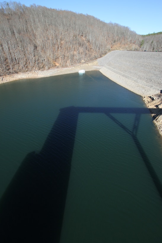 COVINGTON, Va. -- Gathright Dam's intake tower casts a shadow over Lake Moomaw. The earthen and rolled rock-fill dam, pictured in the upper right-hand corner of the photo, impounds the flow of the Jackson River and creates Lake Moomaw, serving both flood control and recreational purposes. (U.S. Army photo/Kerry Solan)