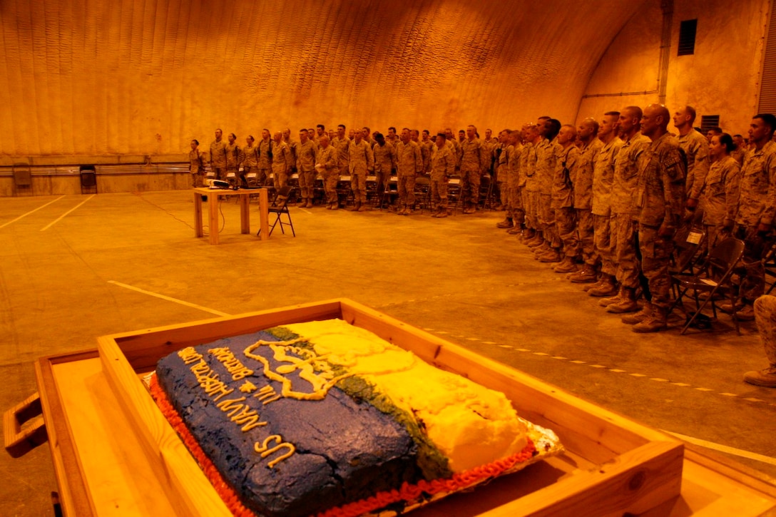 Service members celebrate the 116th birthday of the United States Navy's Hospital Corps, during a ceremony held aboard Camp Leatherneck, Afghanistan, June 17, 2014. The ceremony included a cake cutting with the youngest and oldest corpsmen on Camps Bastion and Leatherneck, and the corpsmen recited their Hospital Corpsman's Pledge.