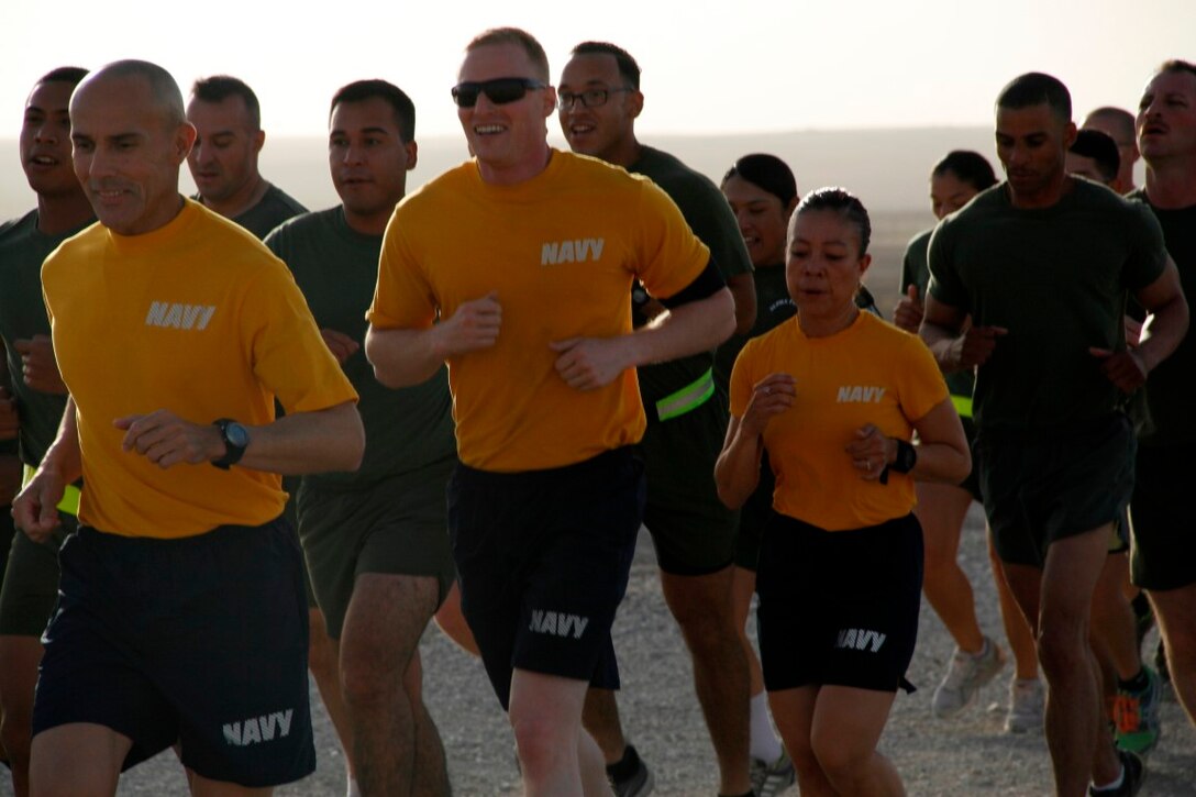 Master Chief Frank Dominguez, left, command master chief, Regional Command (Southwest), leads a formation of sailors on a run aboard Camp Bastion, Helmand province, Afghanistan, June 17, 2014. The 3-mile motivational run was to pay tribute to those men and women who paved the way for today's generation of corpsmen in honor of the 116th anniversary of the U.S. Navy Hospital Corpsman.