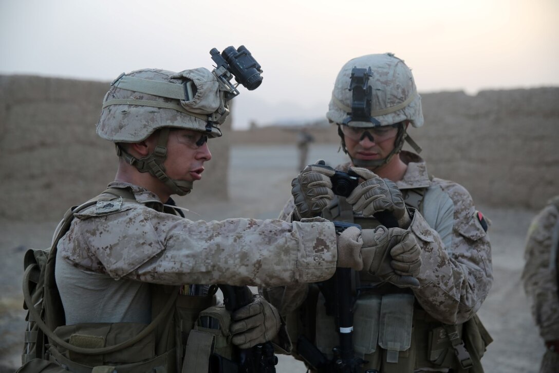 Sergeant Michael Nibler, left, a squad leader with Bravo Company, 1st Battalion, 7th Marine Regiment, and a native of Seattle, documents coordinates during a mission in Helmand province, Afghanistan, June 5, 2014. The company conducted disruption operations in a known Taliban bed-down location for two days. During the previous mission May 29, the company discovered a drug production lab and removed more than one metric ton of narcotics from the battlefield.
(U.S. Marine Corps photo by Cpl. Joseph Scanlan / released)

