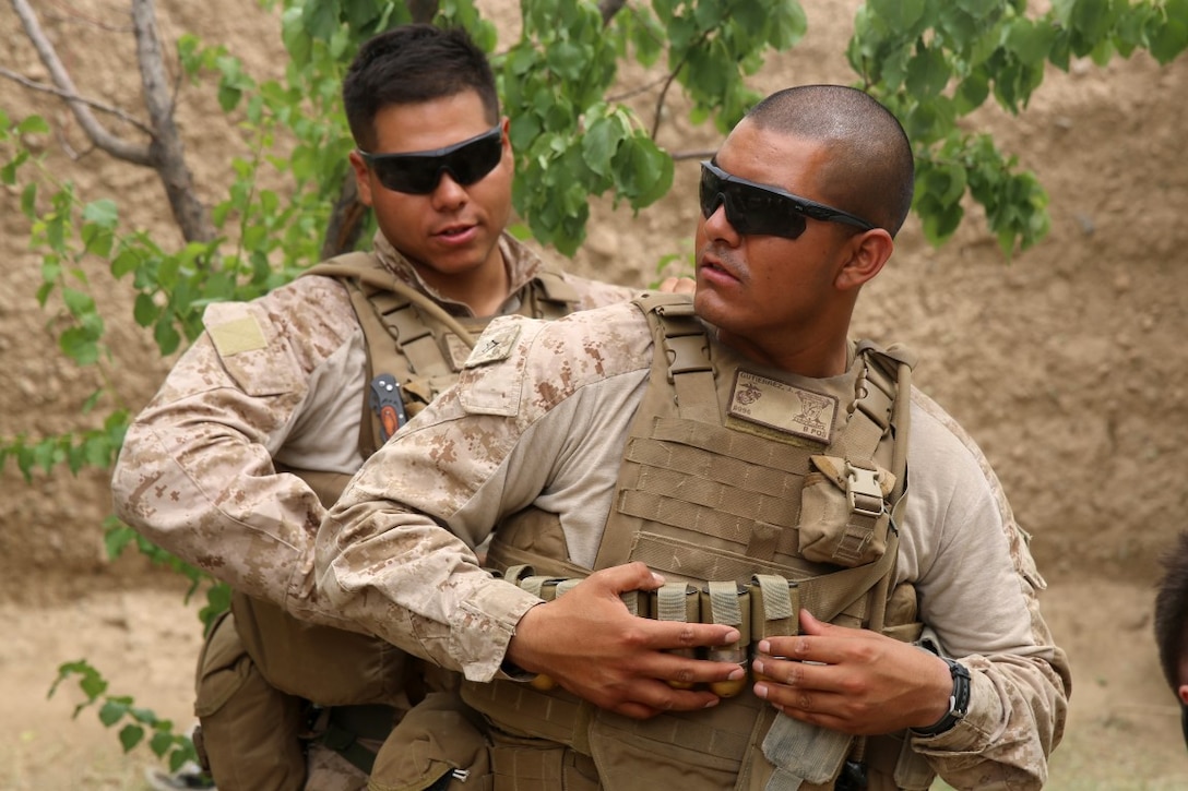 Lance Cpl. Jesse Gutierrez, right, a rifleman with Bravo Company, 1st Battalion, 7th Marine Regiment, and a native of Bakersfield, California, secures 40mm grenades to his plate carrier before a security patrol in Helmand province, Afghanistan, June 6, 2014. The company conducted disruption operations in a known Taliban bed-down location for two days. During the previous mission May 29, the company discovered a drug production lab and removed more than one metric ton of narcotics from the battlefield.
(U.S. Marine Corps photo by Cpl. Joseph Scanlan / released)
