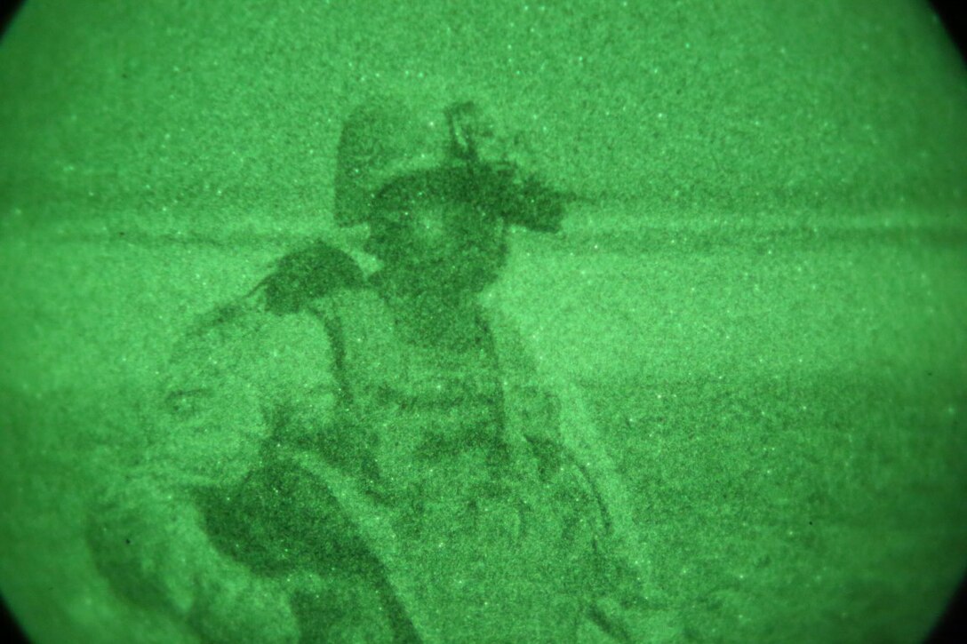 Staff Sgt. Devon Fischer, a platoon sergeant with Bravo Company, 1st Battalion, 7th Marine Regiment, and a native Hillsborough, North Carolina, patrols to a landing zone under the cover of night during a mission in Helmand province, Afghanistan, June 6, 2014. The company conducted disruption operations in a known Taliban bed-down location for two days. During the previous mission May 29, the company discovered a drug production lab and removed more than one metric ton of narcotics from the battlefield.
(U.S. Marine Corps photo by Cpl. Joseph Scanlan / released)

