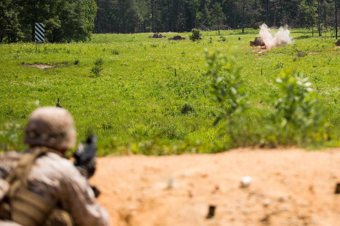 A Company B ceremonial marcher from Marine Barracks Washington, D.C., fires the M203 grenade launcher at the range for grenade launchers and M240 B machine guns in Quantico, Va., June 18, 2014. The Marines regularly train for combat situations as well as their ceremonial duties. (Official Marine Corps photo by Cpl. Dan Hosack/Released)