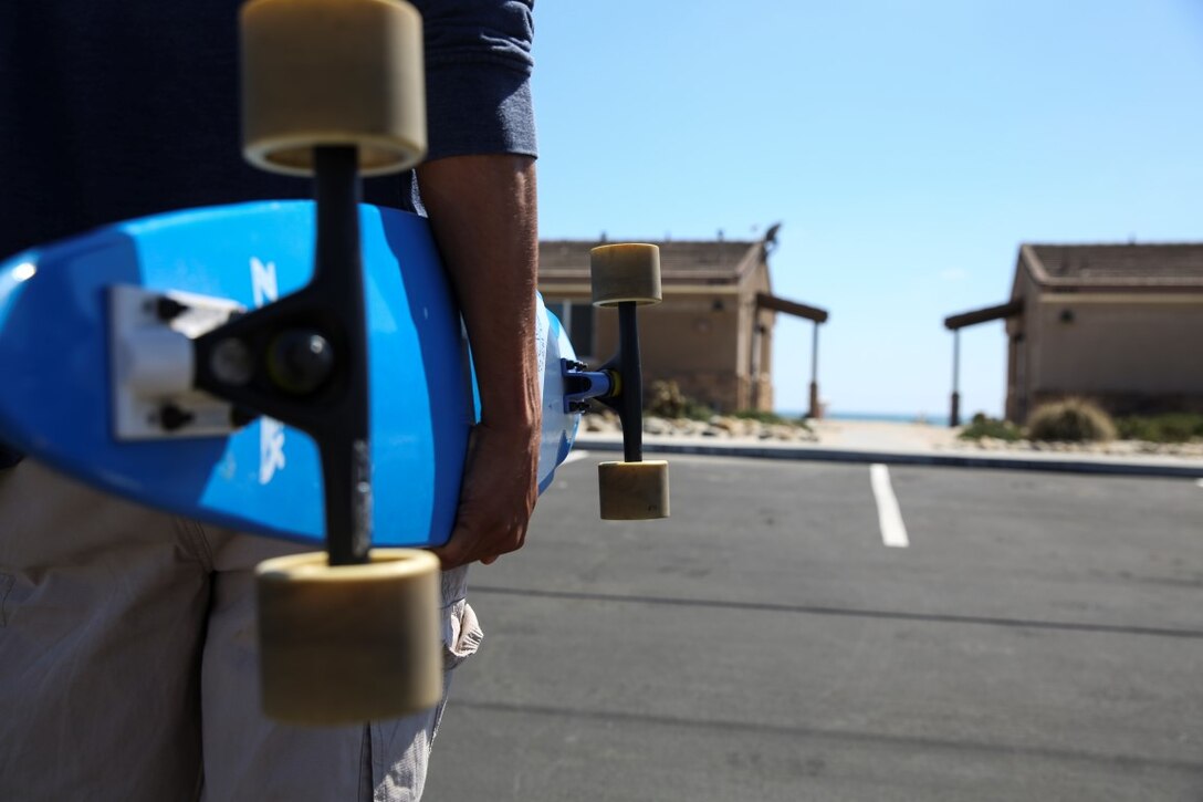 Sergeant Richard Hernandez, cyber network technician, 15th Marine Expeditionary Unit, stands with his longboard aboard Camp Pendleton, Calif., June 13, 2014. Hernandez, 22, is from Temecula, Calif. (U.S. Marine Corps photo by Lance Cpl. Anna Albrecht/Released)