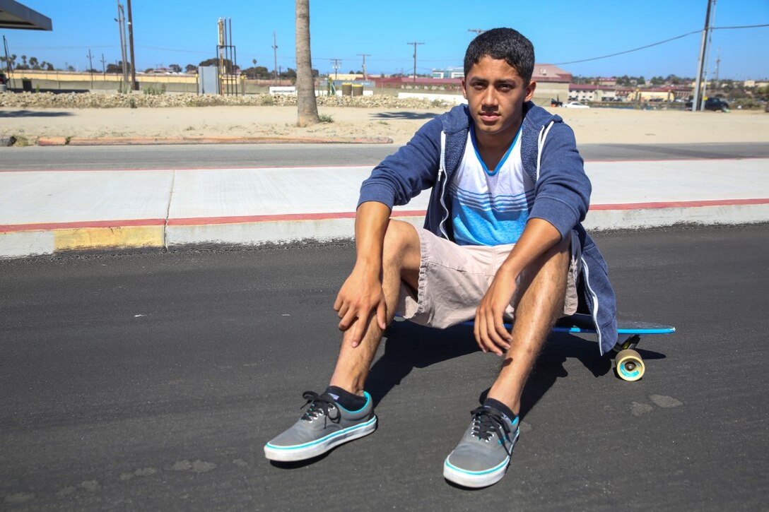 Sergeant Richard Hernandez, cyber network technician, 15th Marine Expeditionary Unit, sits on his longboard aboard Camp Pendleton, Calif., June 13, 2014. Hernandez, 22, is from Temecula, Calif. (U.S. Marine Corps photo by Lance Cpl. Anna Albrecht/Released)