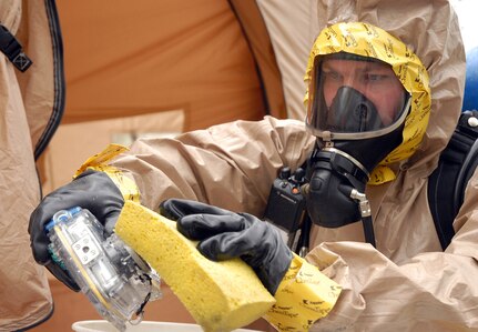 Army Sgt. Joseph Duncan, 73rd Civil Support Team, Kansas National Guard, washes a camera used by a hazardous materials team to photograph the scene during an exercise March 27, 2012, at Wollman Park in Leavenworth, Kansas.