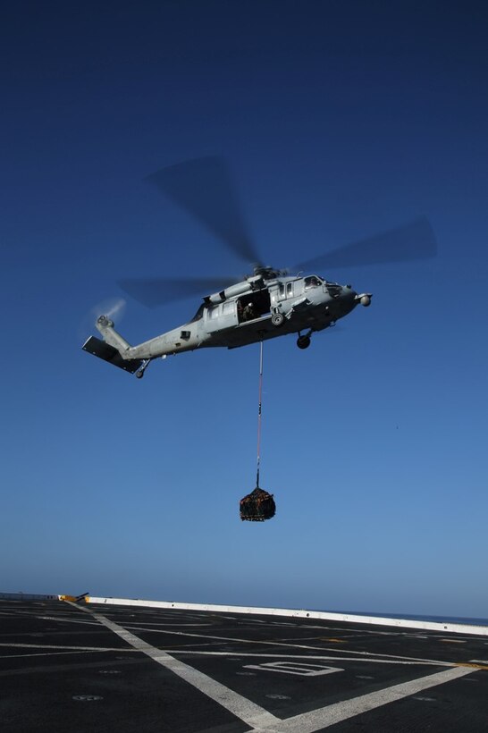 An MH-60S with Helicopter Sea Combat Squadron 23 (HSC-23) Sea Hawk takes off from the flight deck of the USS San Diego for vertical replenishment training during Certification Exercise (CERTEX) off the coast of Southern California, June 18, 2014. CERTEX is the final evaluation of the 11th Marine Expeditionary Unit and Makin Island Amphibious Ready Group prior to deployment. The evaluation requires the Marines and sailors to plan and conduct integrated missions simulated to reflect real-world operations. (U.S. Marine Corps photo by Cpl. Jonathan R. Waldman/RELEASED)