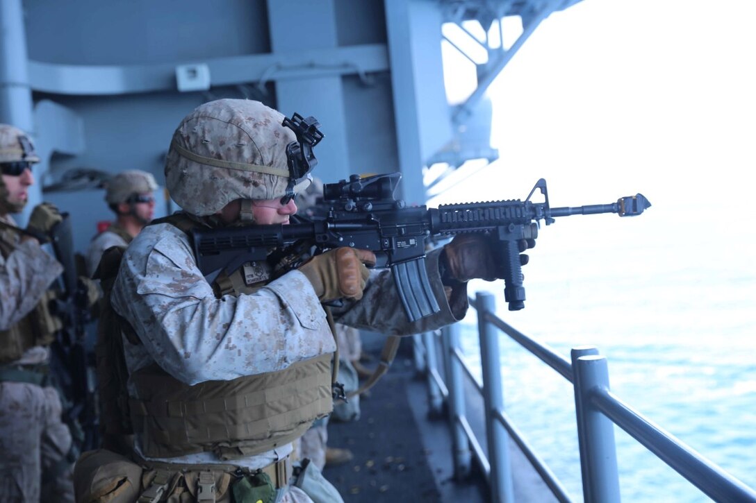 Marines with Fox Company, Battalion Landing Team 2nd Battalion, 1st Marines, 11th Marine Expeditionary Unit, ride in an MV-22B Osprey en route to an embassy reinforcement as part of Certification Exercise (CERTEX) June 14, 2014. The 11th MEU and Amphibious Squadron 5 team conduct CERTEX to hone mission-essential tasks, execute specified MEU and Amphibious Ready Group operations, and certify the foundation of a cohesive warfighting team for exercises and operations they may encounter in their upcoming deployment.  (U.S. Marine Corps photo by Cpl. Demetrius Morgan/Released)