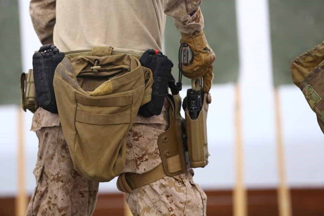 A Marine with the Force Reconnaissance Detachment, 11th Marine Expeditionary Unit, draws a Marine Corps Close Quarters Battle pistol from his holster during a close quarters tactics range on the flight deck of the USS San Diego as part of Certification Exercise (CERTEX) off the coast of Southern California, June 15, 2014. These exercises keep the Marines operationally ready and hone their skills in combat marksmanship. CERTEX is the final evaluation of the 11th MEU and Makin Island Amphibious Ready Group prior to deployment. The evaluation requires the Marines and sailors to plan and conduct integrated missions simulated to reflect real-world operations. (U.S. Marine Corps photo by Cpl Jonathan R. Waldman/RELEASED)