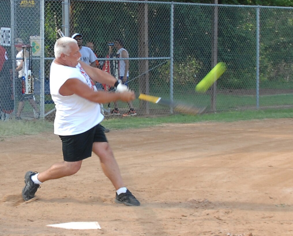 Chuck Peay of Weapons hits a grand slam over the left field fence at the Covella Pond Field here during an intramural softball game, June 11. Weapons beat the Hard Chargers 12-11.