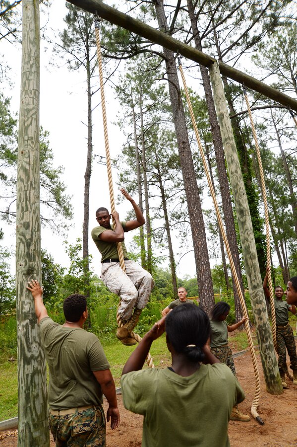 Marine Junior Reserve Officers Training Corps cadets from Dougherty Comprehensive High School, Albany, Ga., watch as Sgt. Marcus Keyes, training noncommissioned officer, Operations and Training Division, Marine Corps Logistics Base Albany, demonstrates the proper technique for mastering the rope climb. The training was completed as part of a leadership camp, June 3.