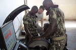 A Mozambique army soldier demonstrates how to balance a tire for U.S. Army Spc. Duston Sorrells, a mechanic with Task Force Raptor, 3rd Squadron, 124th Cavalry Regiment, Texas Army National Guard, during a vehicle mechanic seminar in Maputo, Mozambique, March 20, 2012. Task Force Raptor Soldiers took part in the seminar in support of Combined Joint Task Force - Horn of Africa, whose mission includes building partner nation capacity.