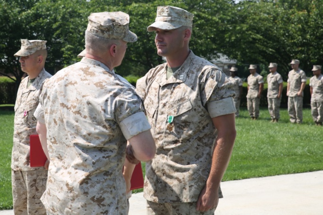 U.S Marine Corps Capt. Joseph Reney (right), a native of Corona, Ca. and 2000 graduate of Corona High School recently received the Navy and Marine Corps Commendation medal June 16 at the Defense Distribution Center Susquehanna, New Cumberland Pa. Reney currently serves as the 4th Marine corps District’s Public Affairs. As the Public Affairs Officer, he is responsible for giving public affairs guidance to the commanding officer and recruiting stations, training Marketing and Public Affairs Marines, and releasing public affairs stories and photos. Reney enlisted in the Marine Corps in December 27, 2000 and commissioned as an officer in 2007. He has been stationed at Marine Corps Air Station Beaufort, Beaufort, S.C, 1st Marine Division Camp Pendleton, CA, and 4th Marine Corps District. Reney deployed to Afghanistan in 2009. His awards include the Navy and Marine Corps Achievement Medal, the Navy Presidential Unit Citation, the Navy Unit Commendation, a Navy Meritorious Unit Commendation, two Marine Corps Good Conduct Medals, the National Defense Service Medal, two Afghanistan Campaign Medals, the Global War on Terrorism Service Medal and two Sea Service Deployment ribbons.(U.S. Marine Corps photo by Cpl. Tyler Birky/RELEASED)