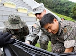 DAEGU, South Korea (June 18, 2014) - Soldiers from the United States Army's 19th Expeditionary Sustainment Command and Republic of Korea Army's 5th Logistics Support Command mark the ROK Remembrance month by cleaning the Apsan Memorial Park.  The month of June is a designated memorial period for all Koreans as well as the anniversary of the start of the Korean War. The U.S. and ROK Army partner in these community activities strengthening the ongoing alliance which has been sustained for over 60 years.  (Photo Credit: Cpl. Dong-weon Kim)  