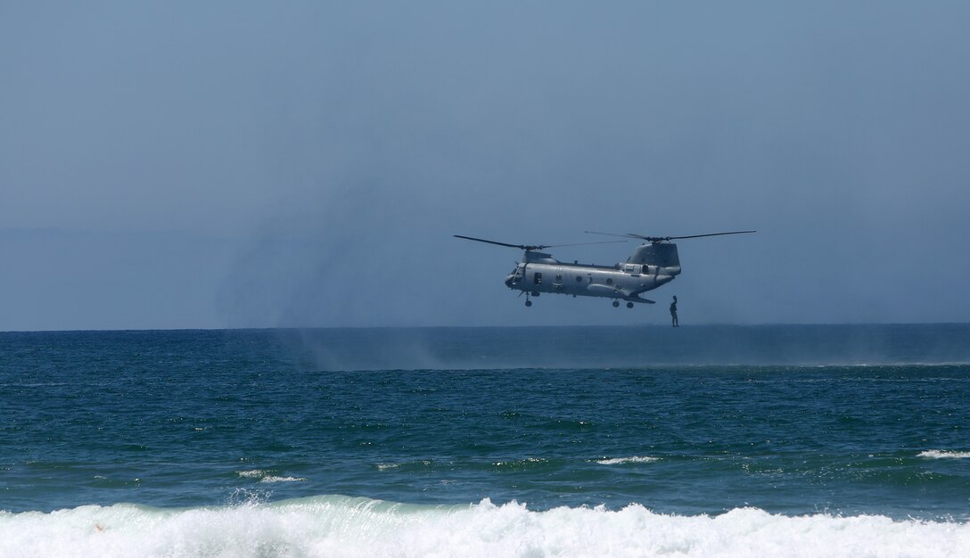 Special Amphibious Reconnaissance Corpsmen (SARC), jump out of a CH-46E Sea Knight during the 116th Hospital Corps birthday ceremony aboard Camp Pendleton, Calif., June 13, 2014. The SARC's swam ashore and later built a battlefield cross in memory of fallen sailors and Marines. (U.S. Marine Corps photo by Lance Cpl. David Silvano/released)