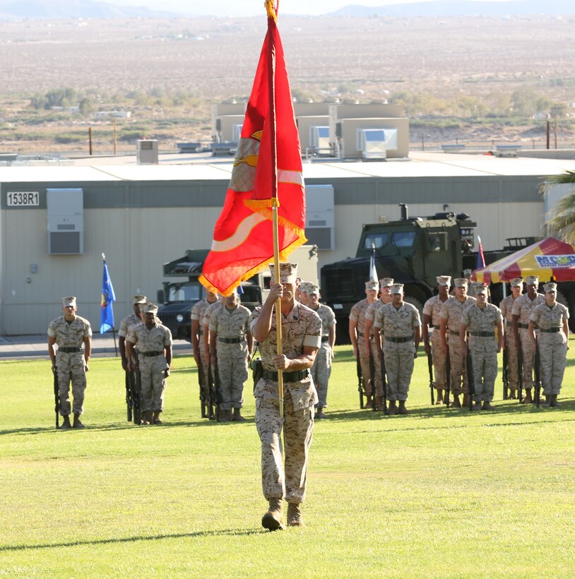 Sgt. Maj. Jason Perry, sergeant major, Unmanned Aerial Vehicle Squadron 3, presents the colors during the squadron's change of command ceremony at Lance Cpl. Torrey L. Gray Field, June 18, 2014. Attendees of the ceremony included Brig. Gen. Mark R. Wise, assistant wing commander, 3rd Marine Aircraft Wing, and Col. Chad Breeden, commanding officer, Marine Air Control Group 38.