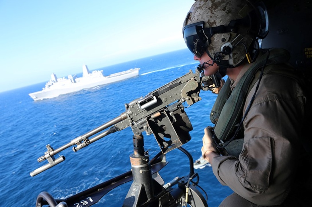 A crew chief with Marine Medium Tiltrotor Squadron 163 (Reinforced), 11th Marine Expeditionary Unit, provides security with an M240G medium machine gun on an UH-1Y Super Huey in support of a visit, board, search and seizure exercise conducted during Certification Exercise off the coast of Southern California, June 16, 2014. The 11th MEU and Amphibious Squadron 5 team conducts CERTEX to hone mission-essential tasks, execute specified MEU and Amphibious Ready Group operations, and certify the foundation of a cohesive warfighting team for exercises and operations they may encounter in their upcoming deployment.