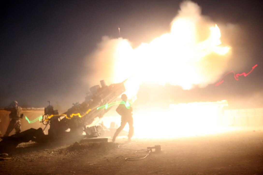 Marines with the Cannons Platoon of Tango Battery, 5th Battalion, 11th Marine Regiment, fire their M777A2 howitzer during a fire mission aboard Camp Bastion, Afghanistan, June 13, 2014. The Marines of Tango Battery aboard Camps Bastion and Leatherneck have a unique makeup for an artillery battery, with one platoon of M777A2 howitzer cannons and one platoon of HIMARS launchers. (U.S. Marine Corps Photo By: Sgt. Frances Johnson/Released)