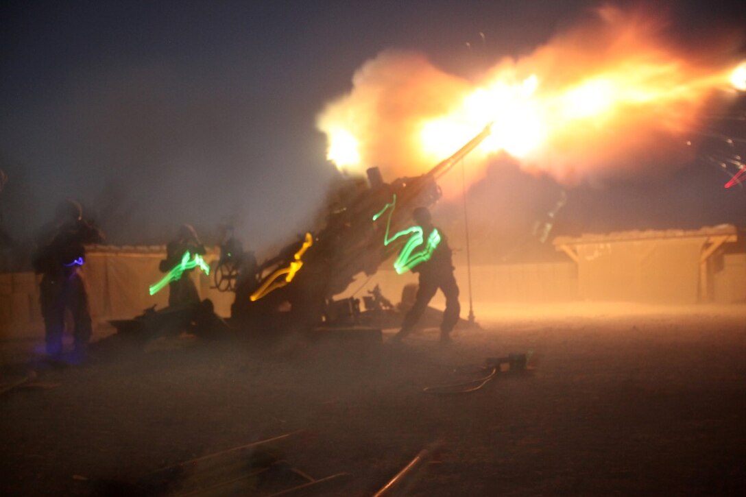 Marines with the Cannons Platoon of Tango Battery, 5th Battalion, 11th Marine Regiment, fire their M777A2 Howitzer during a fire mission aboard Camp Bastion, Afghanistan, June 13, 2014. The Marines of Tango Battery aboard Camps Bastion and Leatherneck have a unique makeup for an artillery battery, with one platoon of M777A2 Howitzer cannons and one platoon of HIMARS launchers. (U.S. Marine Corps Photo By: Sgt. Frances Johnson/Released)