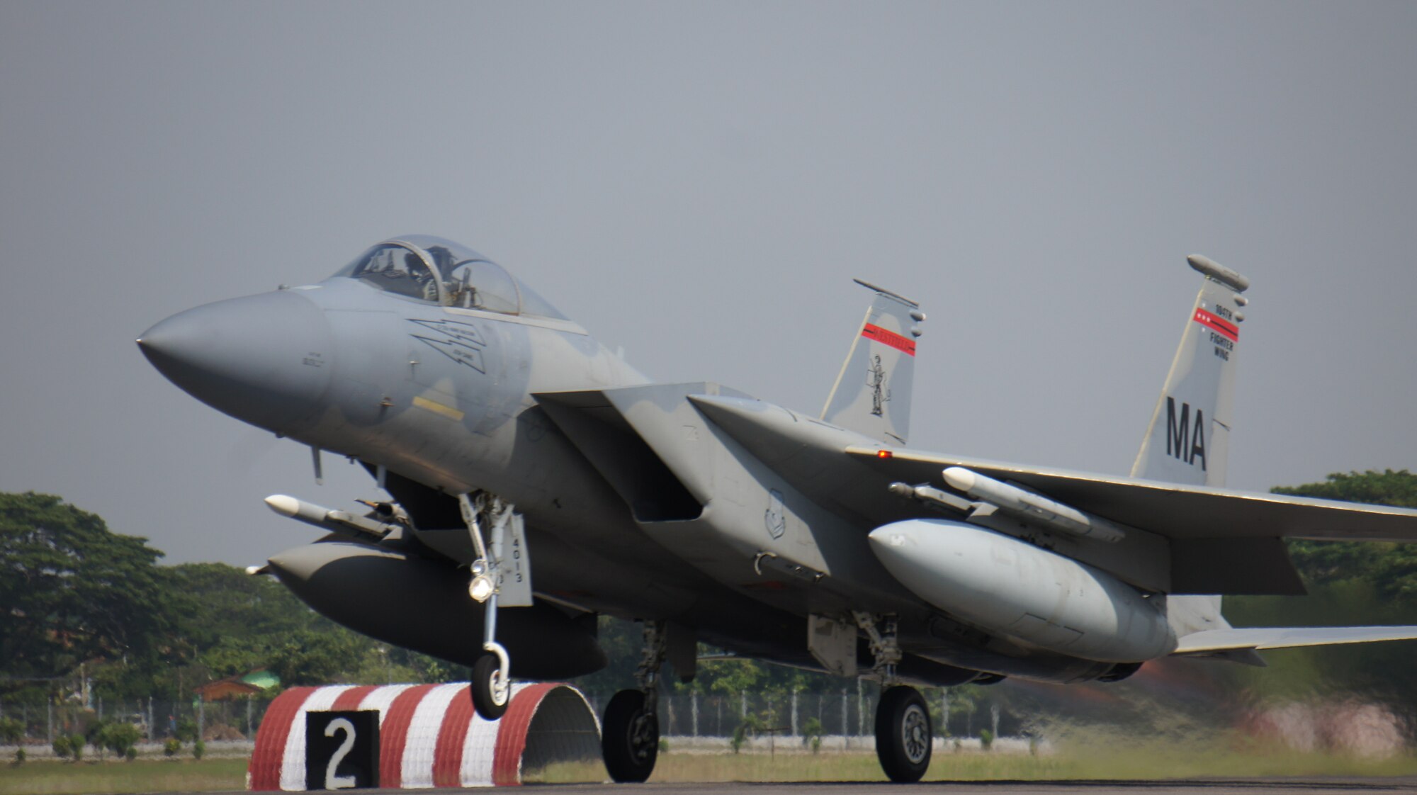 A Massachusetts National Guard F-15 Eagle from the 104th Fighter Wing takes off for the final sortie of Cope Taufan, P. U. Butterworth, Malaysia, June 19, 2014. Cope Taufan is a two week exercise that reinforces U.S. Pacific Command Theater Security Cooperation goals for the Southeast Asian region and demonstrates U.S. capability to project forces strategically in a combined, joint environment. More than 450 Airmen are participating, as well as four U.S. Air Force airframes. (U.S. Air Force Photo By Tech Sgt. Andrew L. Jackson / Unclassified, and Released.)