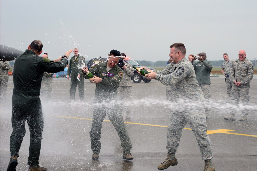 U.S. Air Force Col. Stephen Williams, 35th Fighter Wing commander, battles celebration champagne from Lt. Col. Kevin Jones, 35th Operations Support Squadron Director of Operations, and Command Chief Master Sergeant Gary Sharp, 35 FW, after completing his fini-flight at Misawa Air Base, Japan, June 16, 2014. As Williams nears his departure from Misawa AB, 35 FW personnel took advantage of the opportunity to celebrate his final flight by taking part in the U.S. Air Force’s champagne and water dowsing tradition. (U.S. Air Force photo/Senior Airman Derek VanHorn)