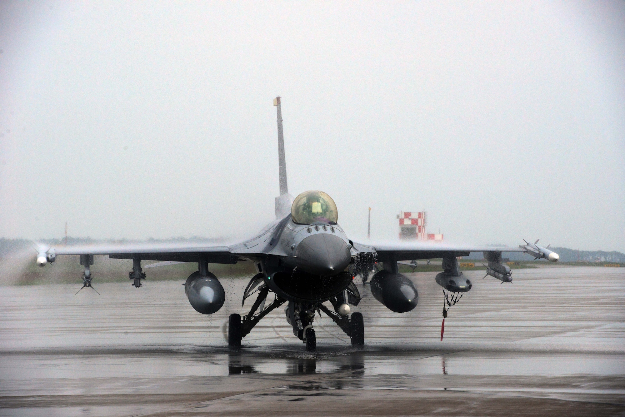 A U.S. Air Force F-16 Fighting Falcon piloted by Col. Stephen Williams, 35th Fighter Wing commander, taxis the flight line at Misawa Air Base, Japan, June 16, 2014. Williams completed his fini-flight at Misawa AB, a final flight that recognized his time as commander of the 35 FW and formally sent him off as he departs to become the commandant of the U.S. Air Force academy. (U.S. Air Force photo/Senior Airman Derek VanHorn)