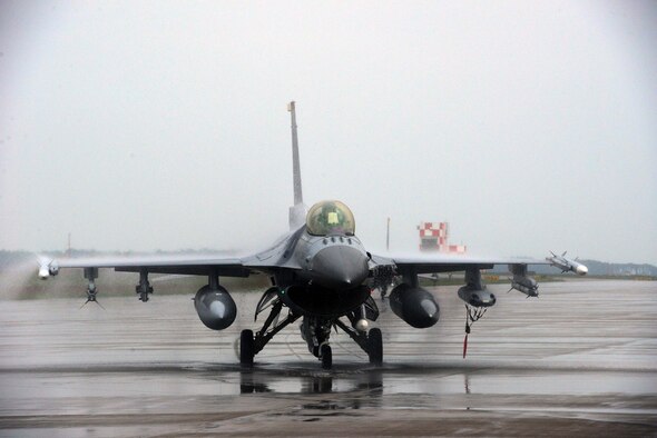 A U.S. Air Force F-16 Fighting Falcon piloted by Col. Stephen Williams, 35th Fighter Wing commander, taxis the flight line at Misawa Air Base, Japan, June 16, 2014. Williams completed his fini-flight at Misawa AB, a final flight that recognized his time as commander of the 35 FW and formally sent him off as he departs to become the commandant of the U.S. Air Force academy. (U.S. Air Force photo/Senior Airman Derek VanHorn)