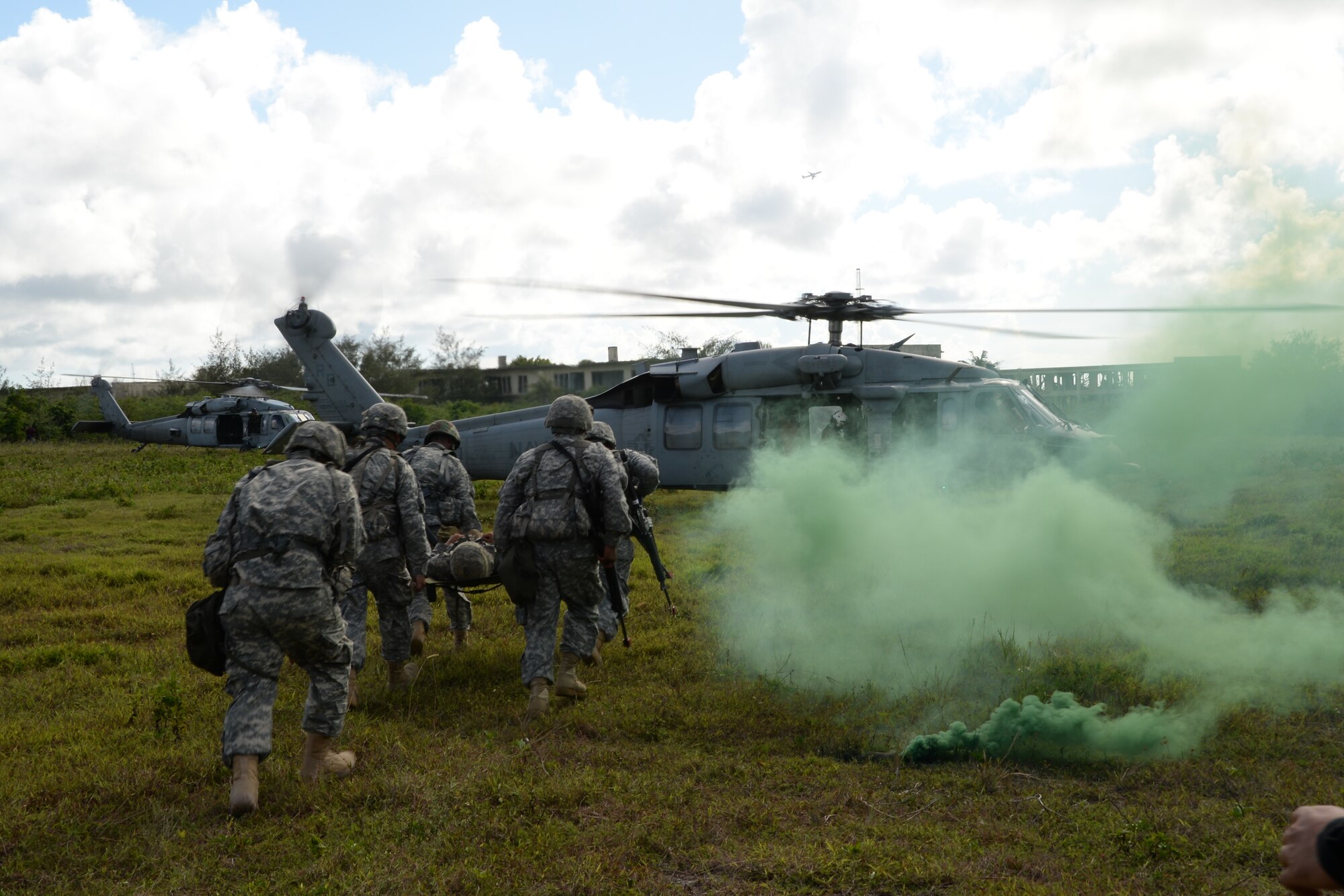 U.S. Army Reserve 797th Engineer Company (Vertical) Soldiers carry a litter to a MH-60S Knighthawk during a training exercise June 11, 2014, on Andersen South, Guam. The training was held to improve the soldiers’ skills for real world contingencies conducted with the help of members of the U.S.  Navy Helicopter Sea Combat Squadron 25 based at Andersen Air Force Base, Guam.  (U.S. Air Force photo by Airman 1st Class Amanda Morris/Released)