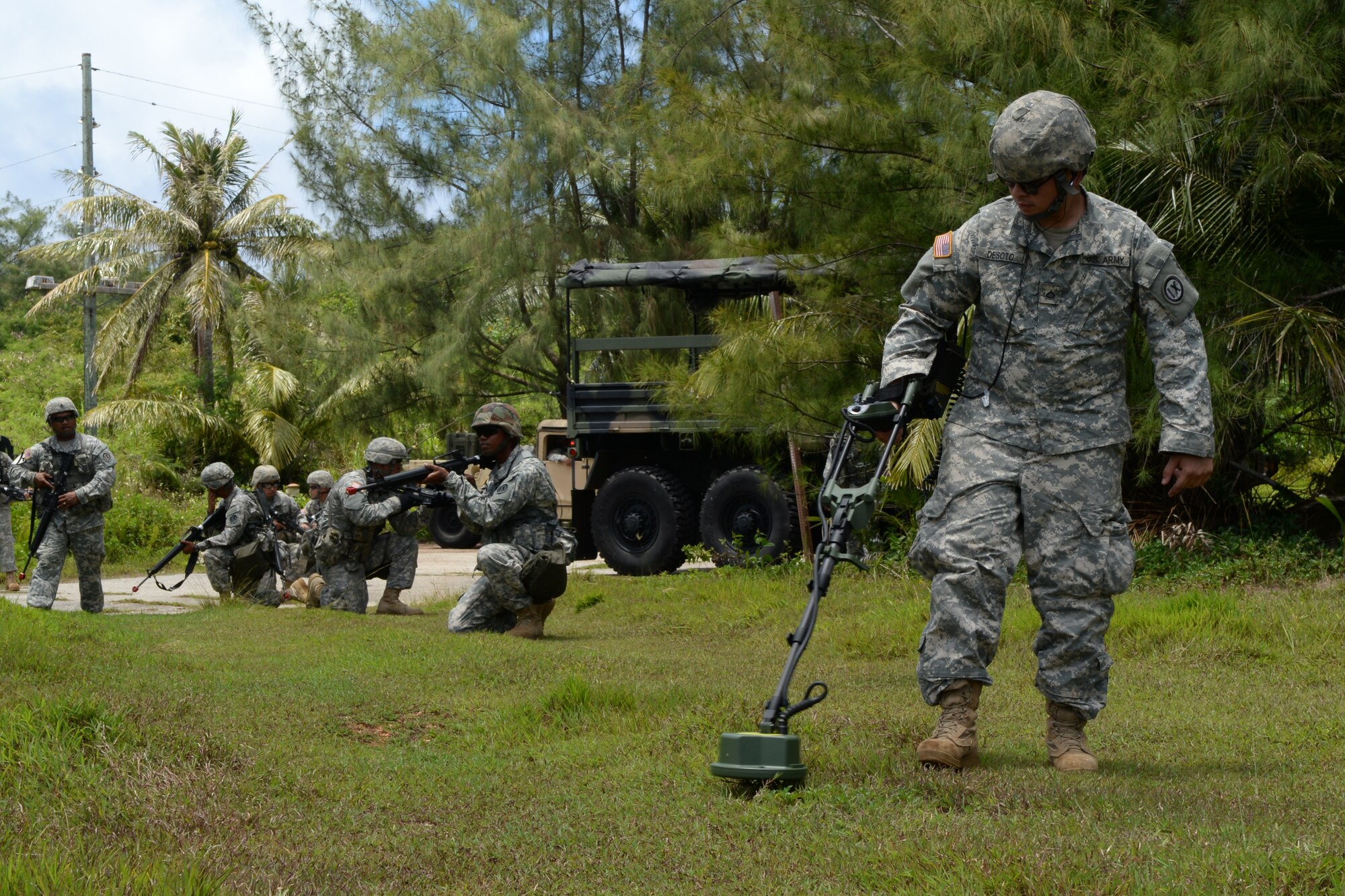 U.S. Army Reserve Pfc. Quentin Matthew Deseto, 797th Engineer Company (Vertical) mine sweeper, clears a training area during an exercise event June 11, 2014, on Andersen South, Guam. The training consisted of classroom instruction, demonstrations and scenario based training. (U.S. Air Force photo by Airman 1st Class Amanda Morris/Released)