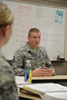 Master Sgt. Aaron Holmes, the Chief Master Sgt. Richard L. Etchberger Airman Leadership School commandant at the Grand Forks Air Force Base, N.D., speaks to ALS students during a class at the North Dakota Air National Guard Base, Fargo, N.D., June 12, 2014. The six-week ALS course is among the first in the country being offered by active-duty instructors at an Air National Guard base. Instructors traveling to students’ location are a cost effective way of conducting training. (U.S. Air Force photo/Senior Master Sgt. David H. Lipp)