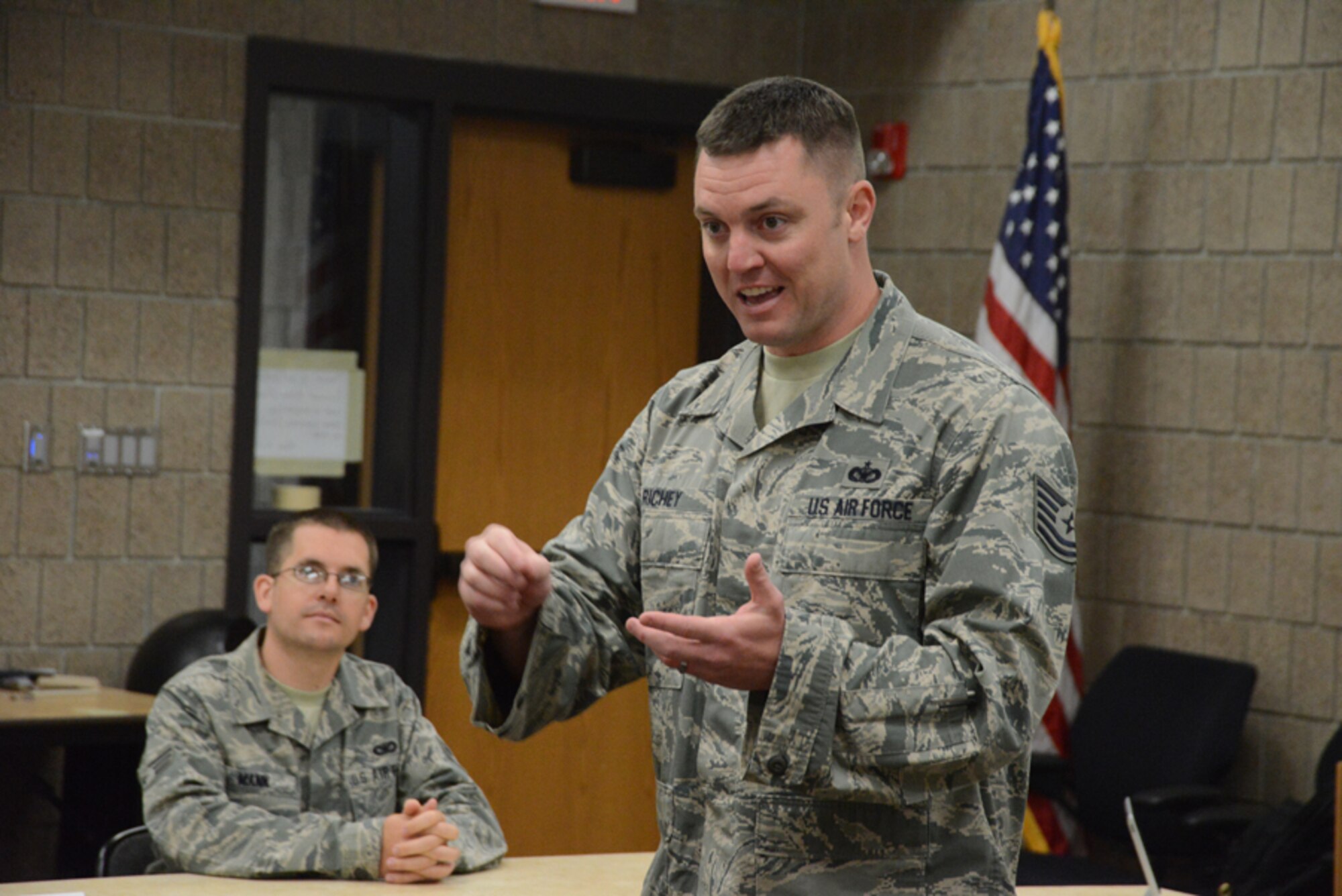 Tech. Sgt. James Richey, an  instructor from the Chief Master. Sgt. Richard L. Etchberger Airman Leadership School at Grand Forks Air Force Base, N.D., right, instructs students about the rules of an interactive knowledge contest during ALS classroom instruction at the North Dakota Air National Guard Base, Fargo, N.D., June 12, 2014, as Senior Airman Christopher Mann looks on. The six-week ALS course is among the first in the country being offered by active-duty instructors at an Air National Guard base. Instructors traveling to students’ location are a cost effective way of conducting training. (U.S. Air Force photo/Senior Master Sgt. David H. Lipp)