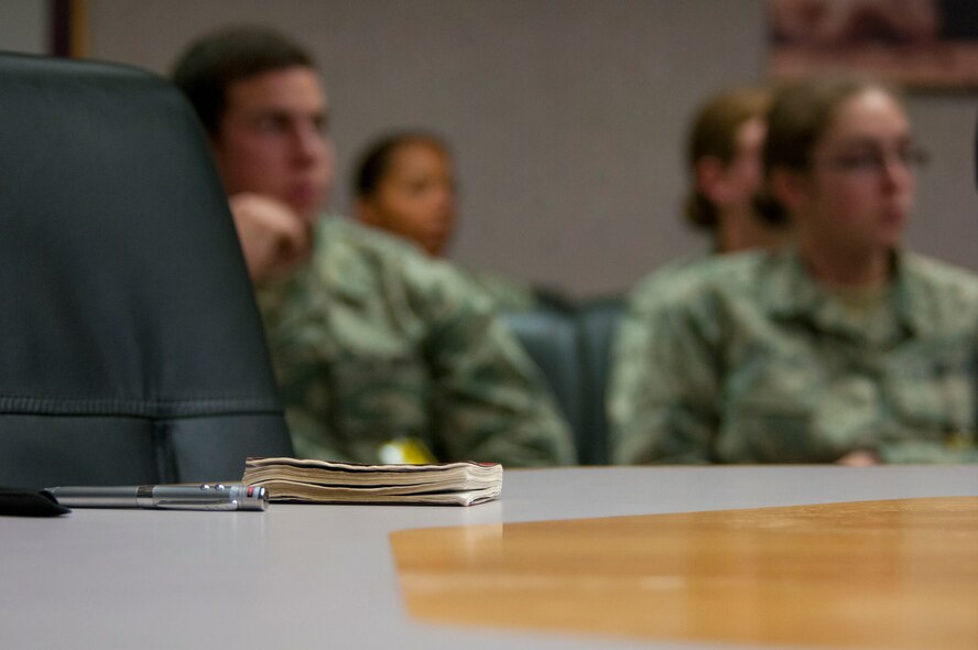 Lt. Col. Matthew Cantore, 3rd Space Experimentation Squadron commander, references his Contrails booklet during a briefing for U.S. Air Force Academy cadets June 16, 2014, at Schriever Air Force Base, Colo. All cadets received this booklet upon entering the Academy. (U.S. Air Force photo/Senior Airman Naomi Griego)