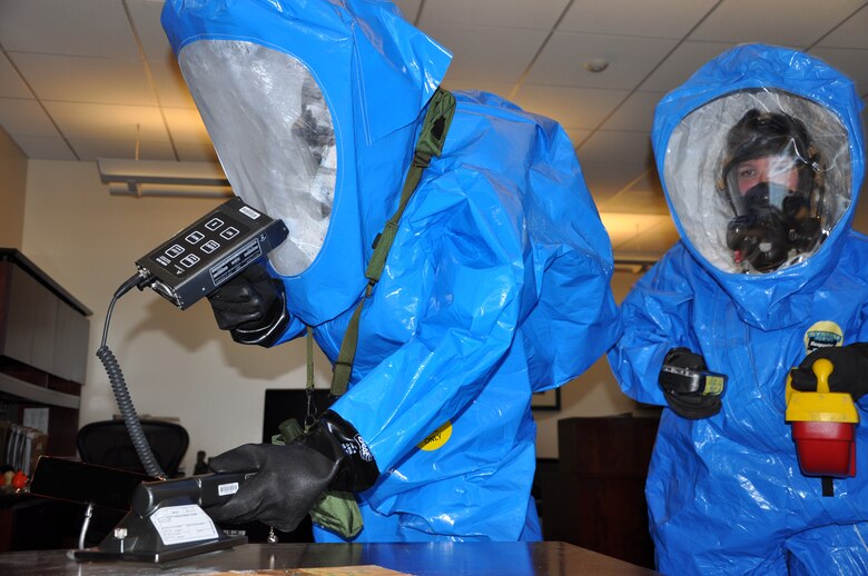 Members of the 21st Space Wing Bioenvironmental Engineering and Emergency Management flight perform radiological and chemical monitoring in Building 210 as part of an exercise June 10, 2014 at Schriever Air Force Base, Colo. (U.S. Air Force photo illustration/Scott Prater) 