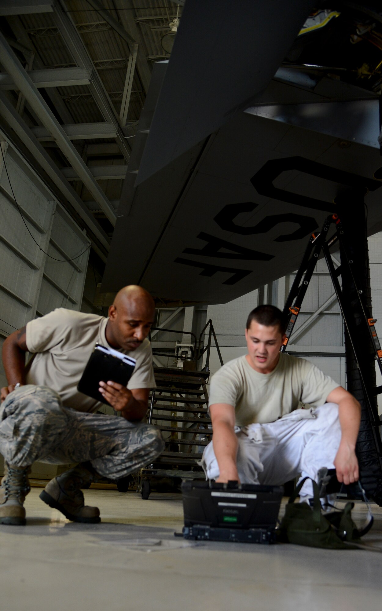 Staff Sgt. Clifford Coleman, 6th Maintenance Group aircraft fuel systems technician, inspects Staff Sgt. Thomas Sinclair, 6th Maintenance Squadron fuels systems repair journeyman, on maintenance procedures June 18, 2014 at MacDill Air Force Base, Fla. Coleman is one of 14 active-duty and three reservists that make up the maintenance quality assurance shop. (U.S. Air Force photo Senior Airman Jenay Randolph/Released)