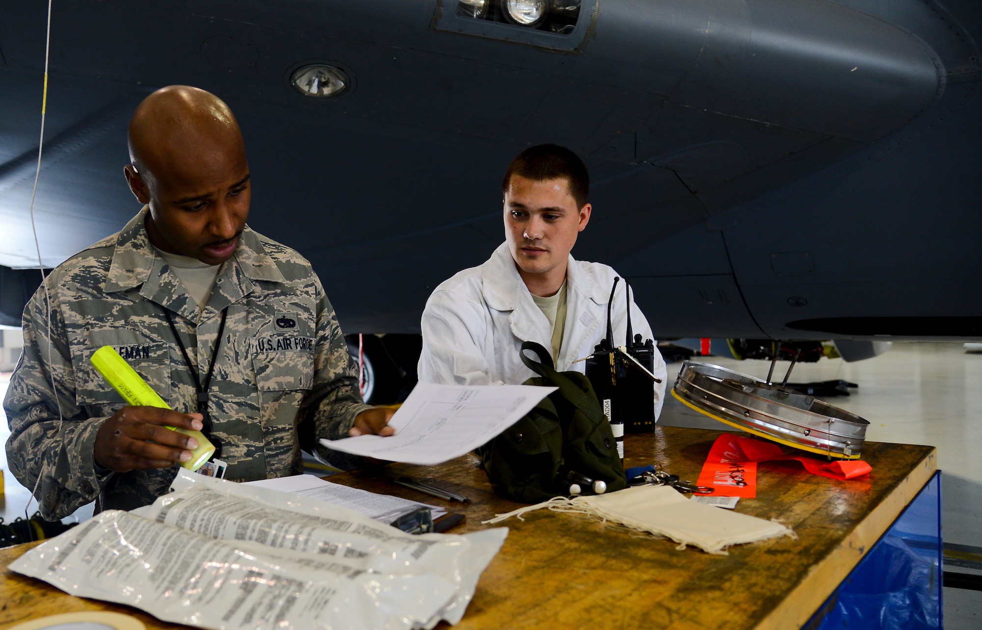 Staff Sgt. Clifford Coleman, 6th Maintenance Group aircraft fuel systems technician, reviews the inspection checklist with Staff Sgt. Thomas Sinclair, 6th Maintenance Squadron fuels systems repair journeyman, June 18, 2014 at MacDill Air Force Base, Fla. Coleman is one of 14 active-duty and three reservists that make up the maintenance quality assurance shop. (U.S. Air Force photo Senior Airman Jenay Randolph/Released) 