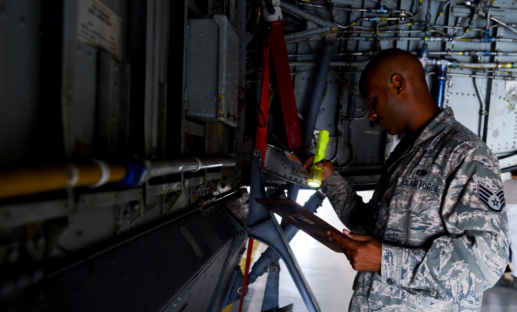 Staff Sgt. Clifford Coleman, 6th Maintenance Group aircraft fuel systems technician, inspects a KC-130 Stratotanker during a maintenance inspection June 18, 2014 at MacDill Air Force Base, Fla. Maintenance quality assurance Airmen's main mission is to provide group commanders with detailed information on how Airmen are performing maintenance and to provide corrective actions to avoid any mishaps in the work station. (U.S. Air Force photo Senior Airman Jenay Randolph/Released)