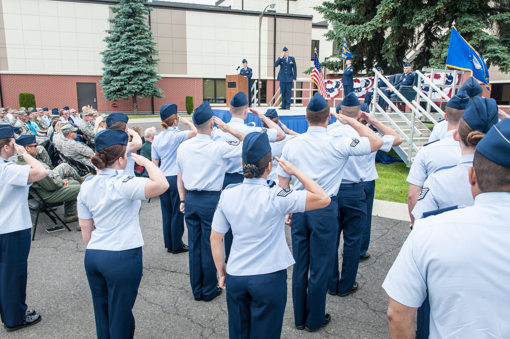 Lt. Col. Dane Campbell salutes members of the 92nd Medical Operations Squadron for the first time as their commander during the 92nd MDOS change of command ceremony at Fairchild Air Force Base, Wash., June 19, 2014. A change of command is a military tradition that represents a formal transfer and responsibility for a unit from one commanding officer to another. Campbell now serves as the 92nd MDOS commander and comes to Fairchild after serving as the 60th Medical Operations Squadron mental health flight commander at Travis Air Force Base, Calif. Former 92nd MDOS commander, Lt. Col. Jason Lennen, and his family, leave Fairchild for the U.S. Air Force War College at Maxwell Air Force Base, Ala. (U.S. Air Force photo by Staff Sgt. Benjamin W. Stratton/Released)
