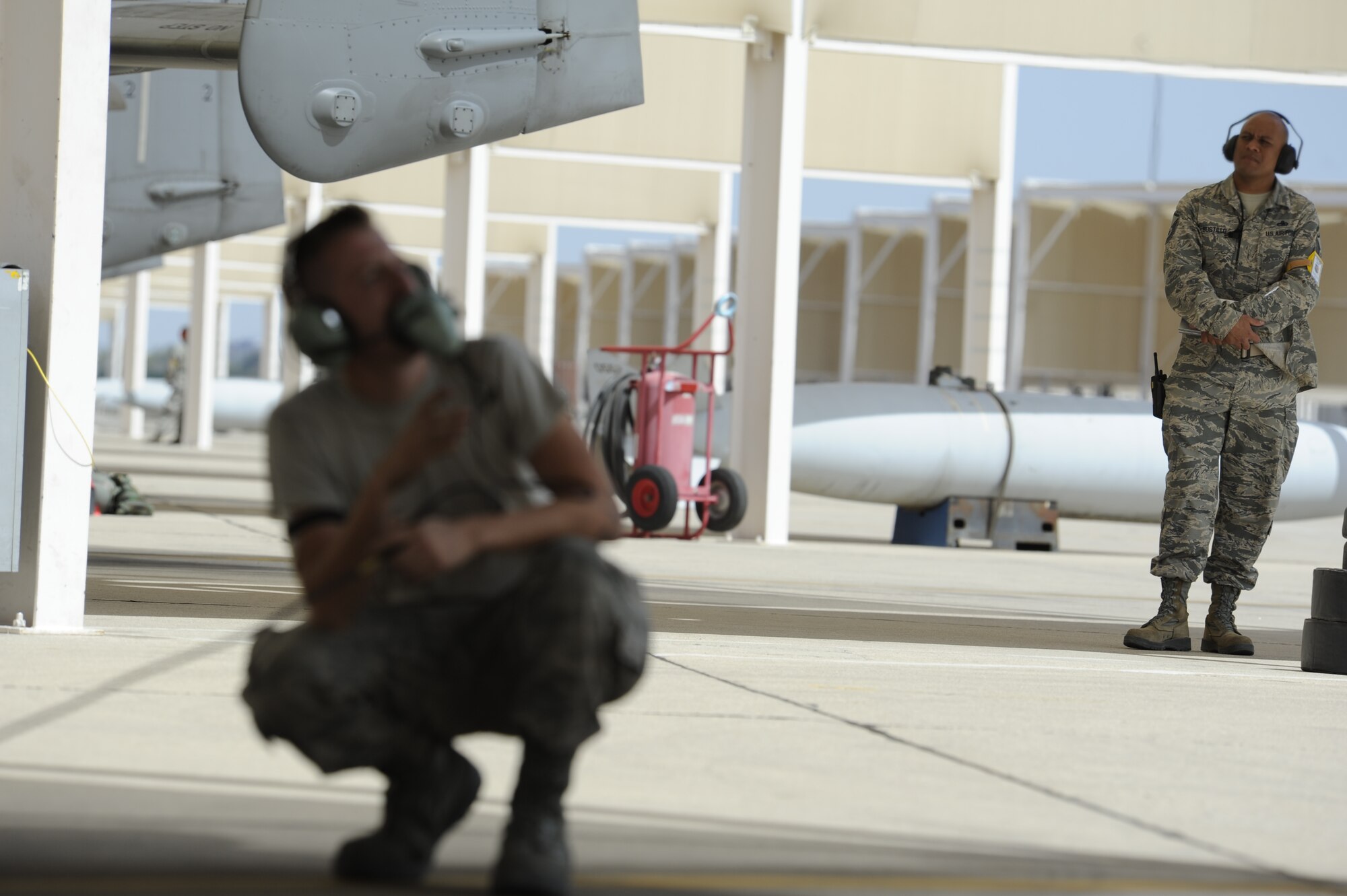 U.S. Air Force Master Sgt. Ronald Bustillo, 355th Maintenance Group Wing Inspection Team lead, observes Airmen during an Operational Readiness Exercise held at Davis-Monthan Air Force Base, Ariz., June 18, 2014. Maintenance personnel were tested on their capability to maintain and generate aircraft for takeoff during fluctuating force protection conditions. (U.S. Air Force photo by Airman 1st Class Betty R. Chevalier/Released)