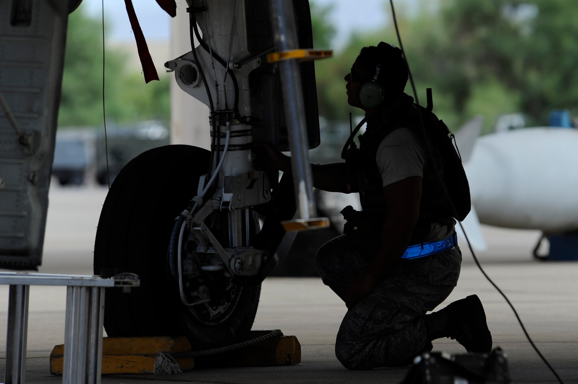 A crew chief assigned to the 354th Aircraft Maintenance Squadron performs a post flight inspection on the tires of an A-10C Thunderbolt II during an Operational Readiness Exercise held at Davis-Monthan Air Force Base, Ariz., June 18, 2014. Airmen demonstrated their ability to employ and sustain forces during simulated attacks and fluctuating force protection conditions. (U.S. Air Force photo by Airman 1st Class Betty R. Chevalier/Released)