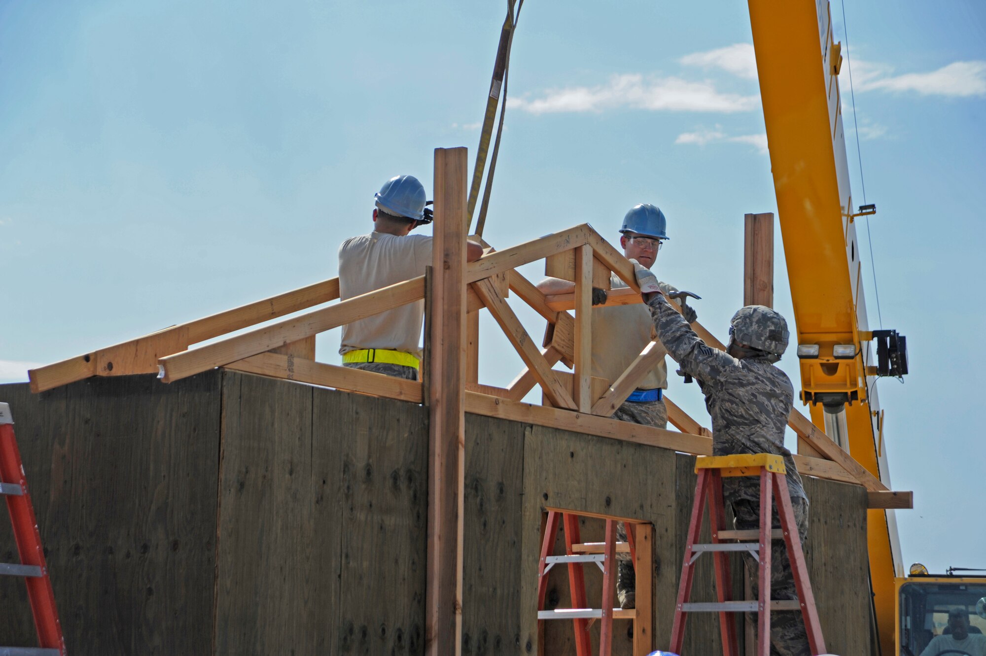 U.S. Air Force Airman assigned to the 355th Civil Engineer Squadron build a roof for a structure at a simulated deployed location, during an Operational Readiness Exercise held at Davis-Monthan Air Force Base, Ariz., June 17, 2014. The ORE gave Airmen an idea of what to do in a deployed area, while giving base leadership an idea of what situations need more awareness. (U.S. Air Force photo by Airman 1st Class Betty R. Chevalier/Released)