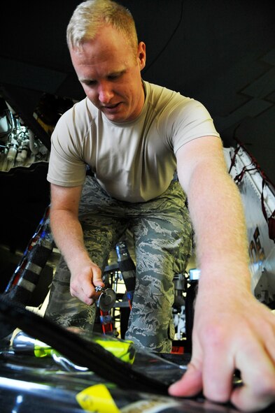 Senior Airman Matthew Quick, 509thAircraft Maintenance Squadron electrical environmental journeyman, grabs a. inspection mirror at Whiteman Air Force Base, Mo., June 10, 2014. The inspection mirror is used to assist in ensuring components are properly installed. (U.S. Air Force photo by Airman 1st Class Keenan Berry/Release)