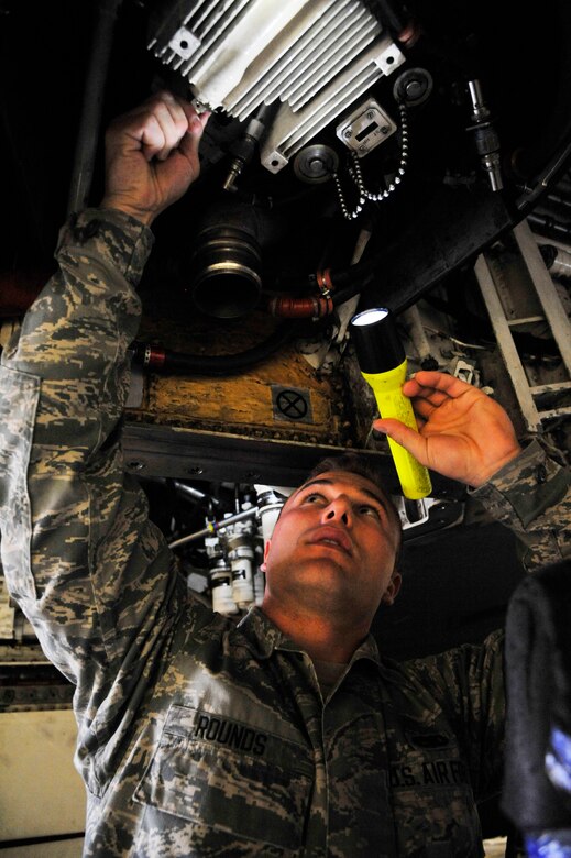U.S. Air Force Dylan Rounds, 509thAircraft Maintenance Squadron aerospace systems propulsion journeyman, inspects an auxiliary power unit at Whiteman Air Force Base, Mo., June 10, 2014. The chip detector must be inspected ensure there is no contamination inside the oil. (U.S. Air Force photo by Airman 1st Class Keenan Berry/Release)