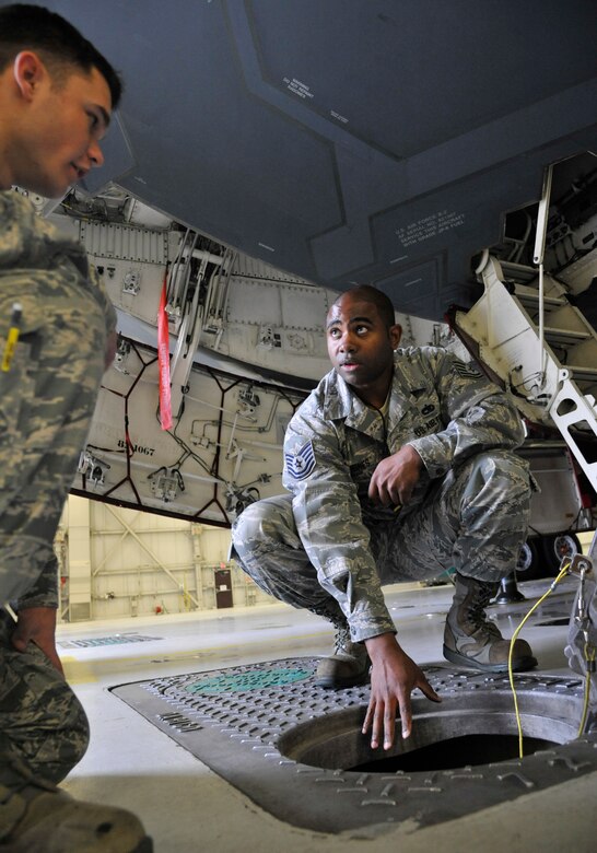 U.S. Air Force Tech Sgt. Broderick Jones, 509th Aircraft Maintenance Squadron aircraft electrical and environmental systems craftsman, explains each dock’s ability to provide cooling air to Airman 1st Class Evan Miesner, 509th AMXS electrical environmental apprentice, at Whiteman Air Force Base, Mo., June 10, 2014. Each dock is capable of providing cooling air to the aircraft for operational checks and maintenance. (U.S. Air Force photo by Airman 1st Class Keenan Berry/Release) 